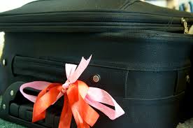 Ribbon tied to suitcase to make it easy to locate at Nashville International Airport